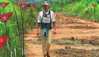 In a flak jacket and face shield, Princess Diana walks along a cleared path on a landmine site in Angola for the Halo Trust in 1997, raising global awareness about the dangers of landmines and contributing to the signing of the Ottawa Treaty banning their use