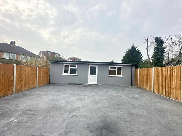 At the far end now stands a 1,229 sq ft storage shed, painted the same slate grey as the rest of the house, dominating the small outdoor space