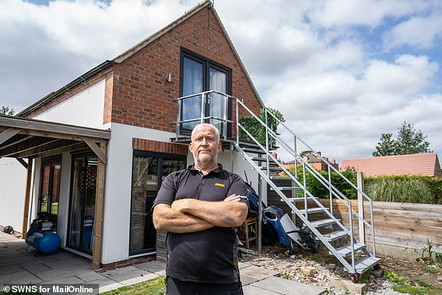 A gas engineer has illegally chopped down a protected willow tree and built an sprawling two-storey 'man cave' in his back garden