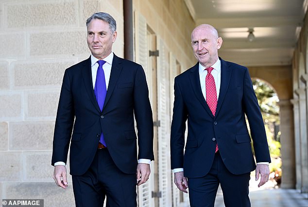 Foreign Minister Marles (left) signed a 50-year deal with UK counterpart John Healey (right)
