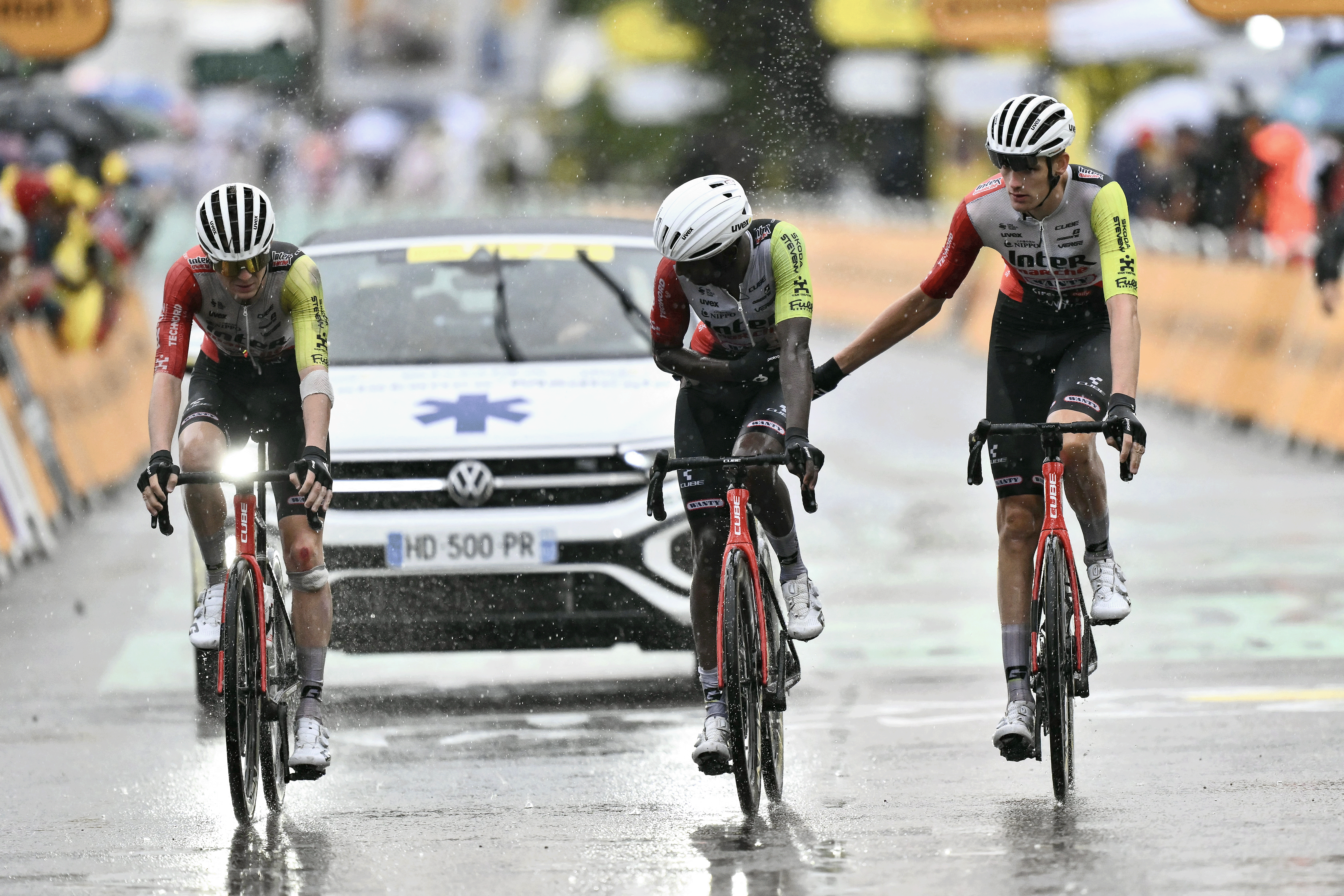 Intermarche - Wanty team's Eritrean rider Biniam Girmay (C) crosses the finish line with teammates, nursing injuries after a mass crash in the final metres of the 17th stage of the 112th edition of the Tour de France cycling race, 160.4 km between Bollene and Valence, southern France, on July 23, 2025. (Photo by Marco BERTORELLO / AFP) (Photo by MARCO BERTORELLO/AFP via Getty Images)