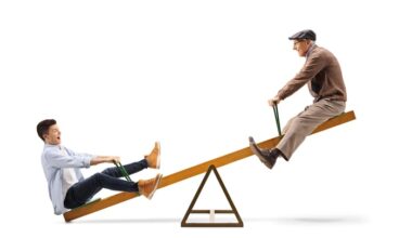 Two people riding a seesaw.