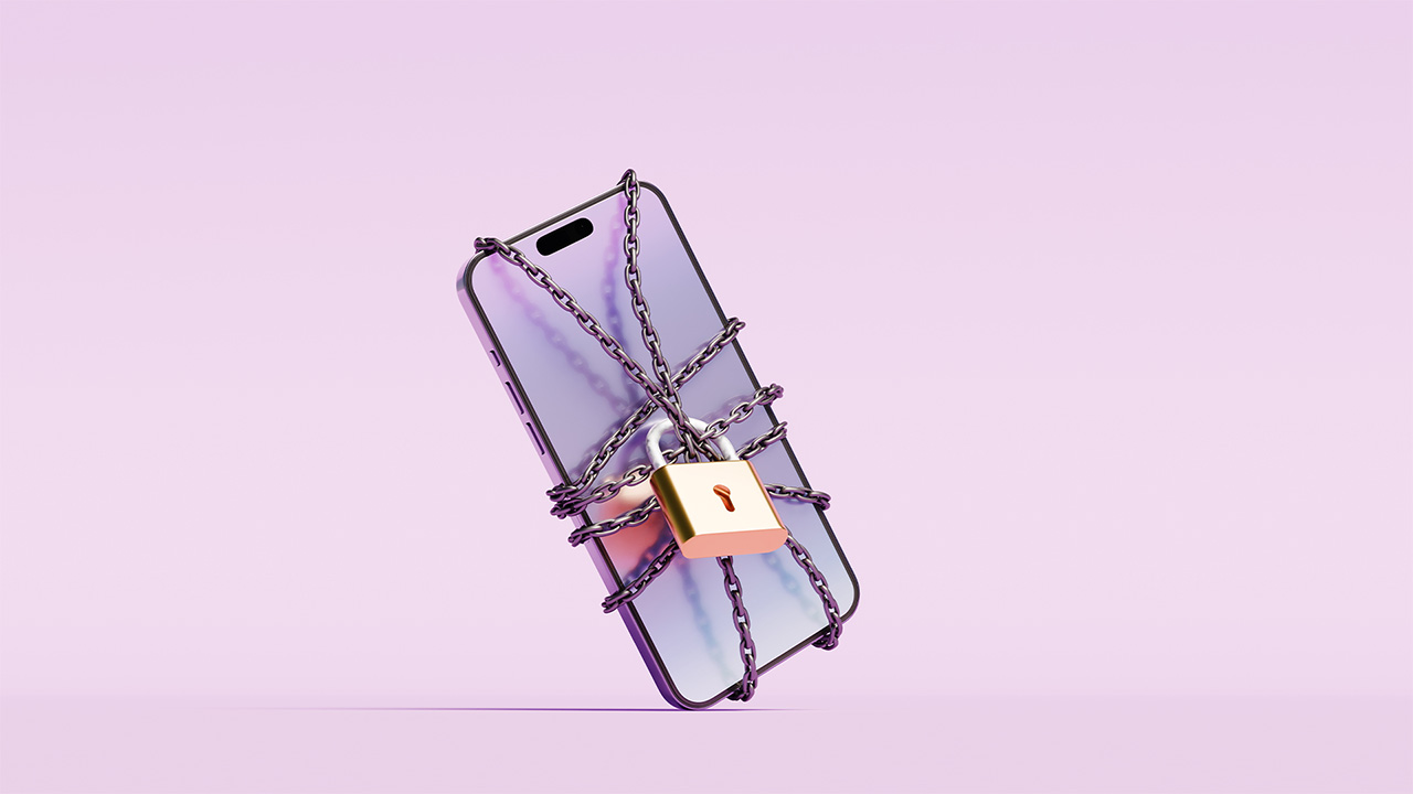 Smartphone on lilac background wrapped in chain and padlocked