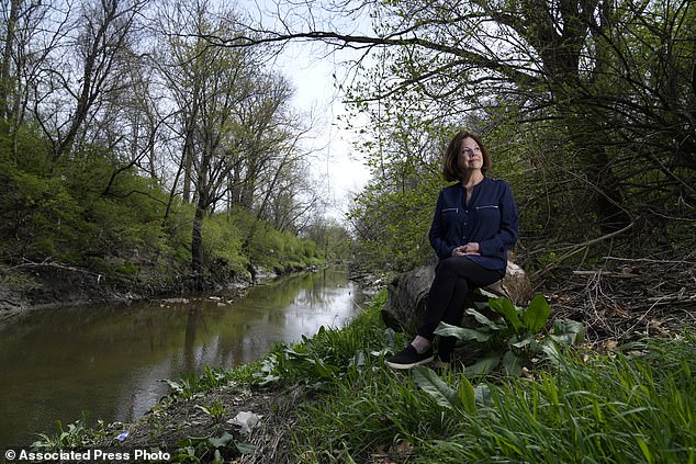 Susie Gaffney poses for a photo along Coldwater Creek near where she used to live. The creek was contaminated when nuclear waste from the Manhattan Project flowed into the waterway. St. Louis played an important role in the country's effort to build the first nuclear weapon