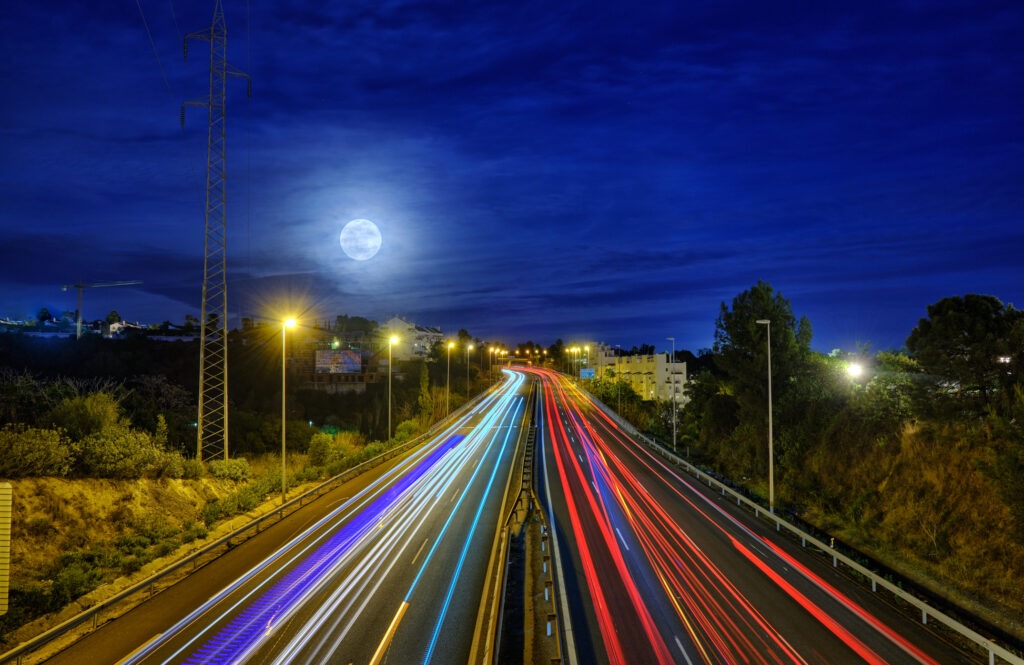 car light trails in a busy motorway on a sunset