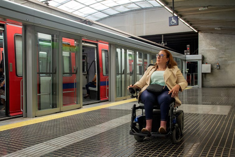 woman using a wheelchair commuting on public transport