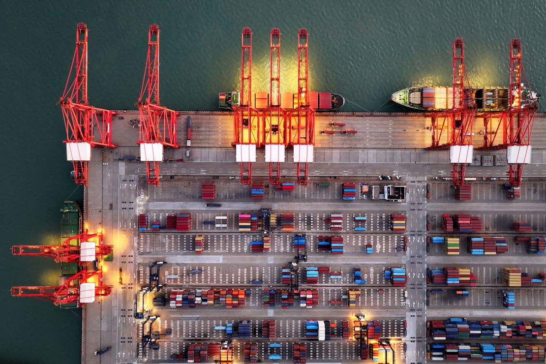 Container ships are seen at the container terminal at Lianyungang port, in China's eastern Jiangsu province in the early morning on July 24, 2025.
