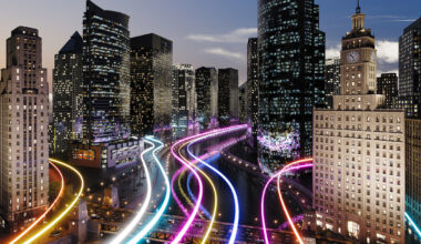 Glowing light trails surround the smart city. (3d render)