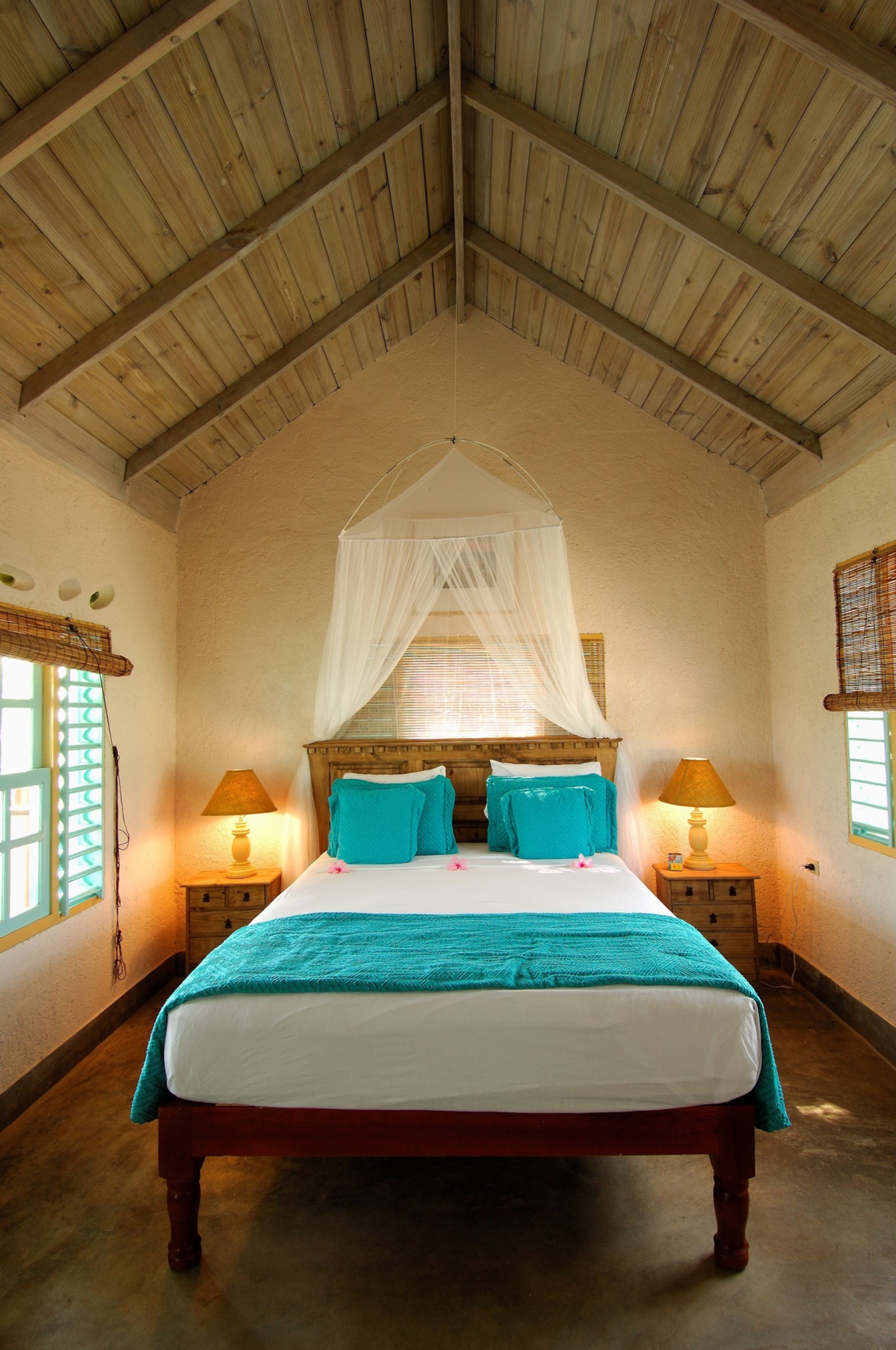 A bed draped with a canopy overhead.