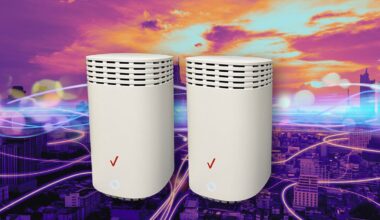 Two routers sit next to each other on a multicolor background