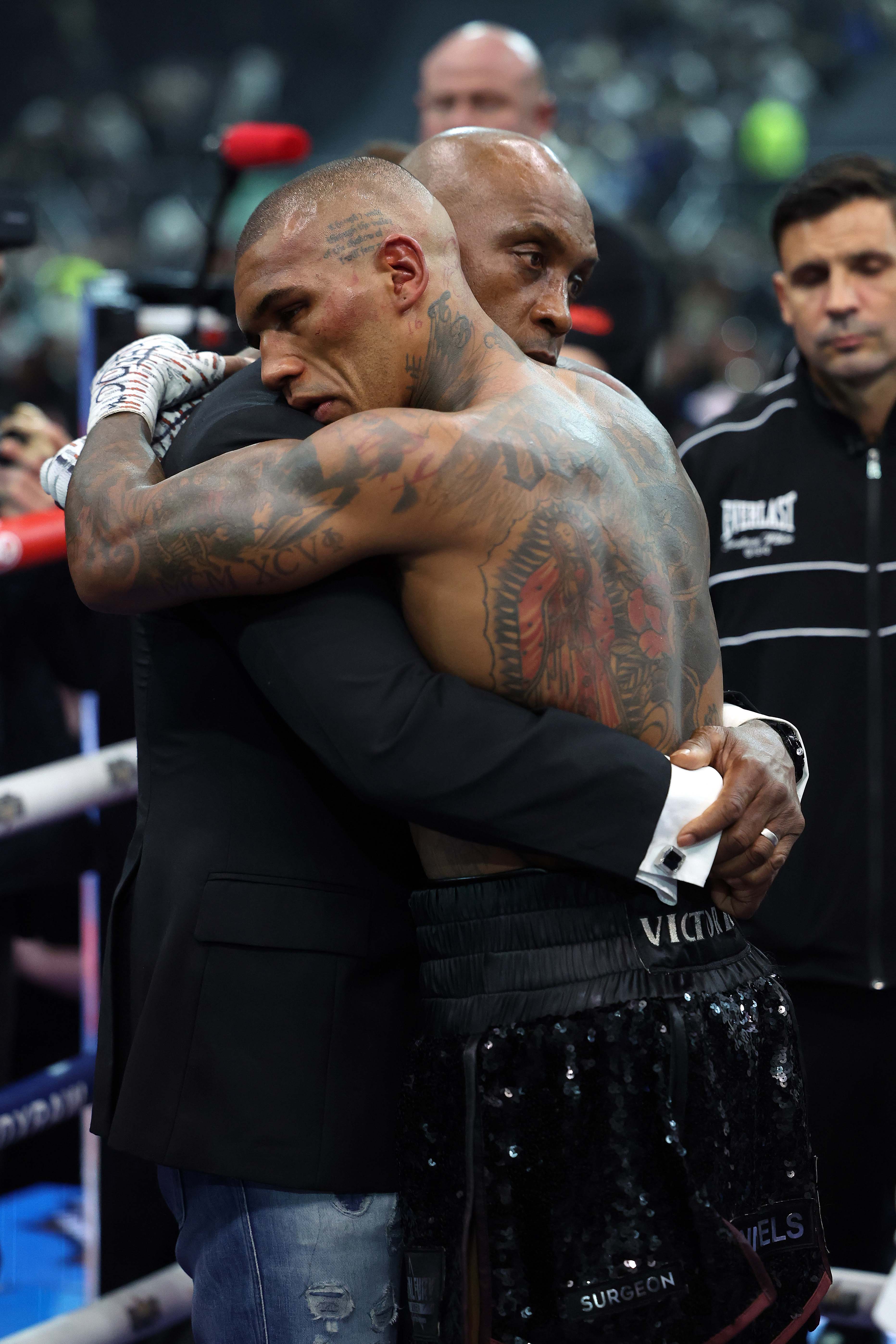 Conor Benn being comforted by his father, Nigel Benn, after a boxing match.