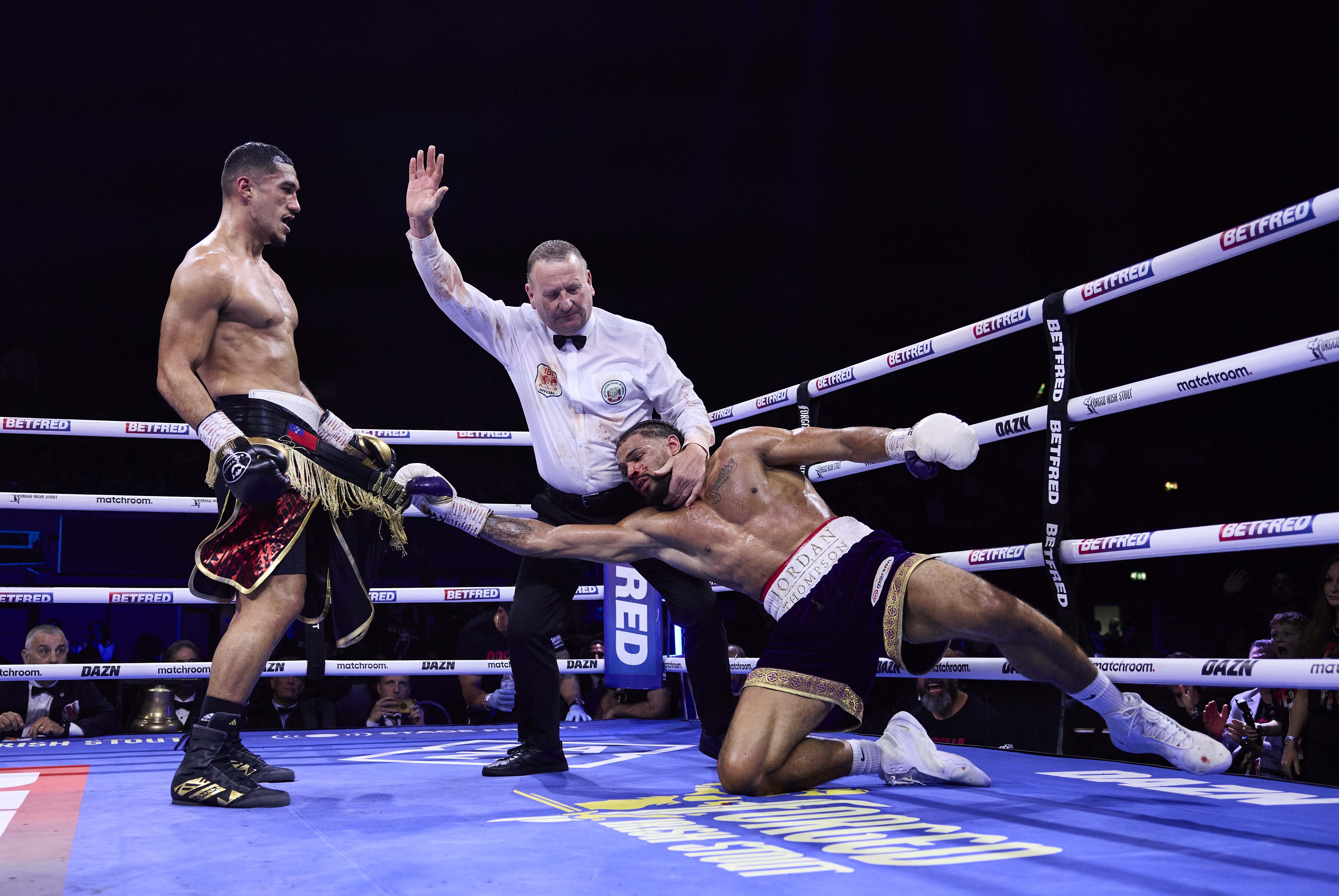 Jai Opetaia knocks down Jordan Thompson in a boxing match.