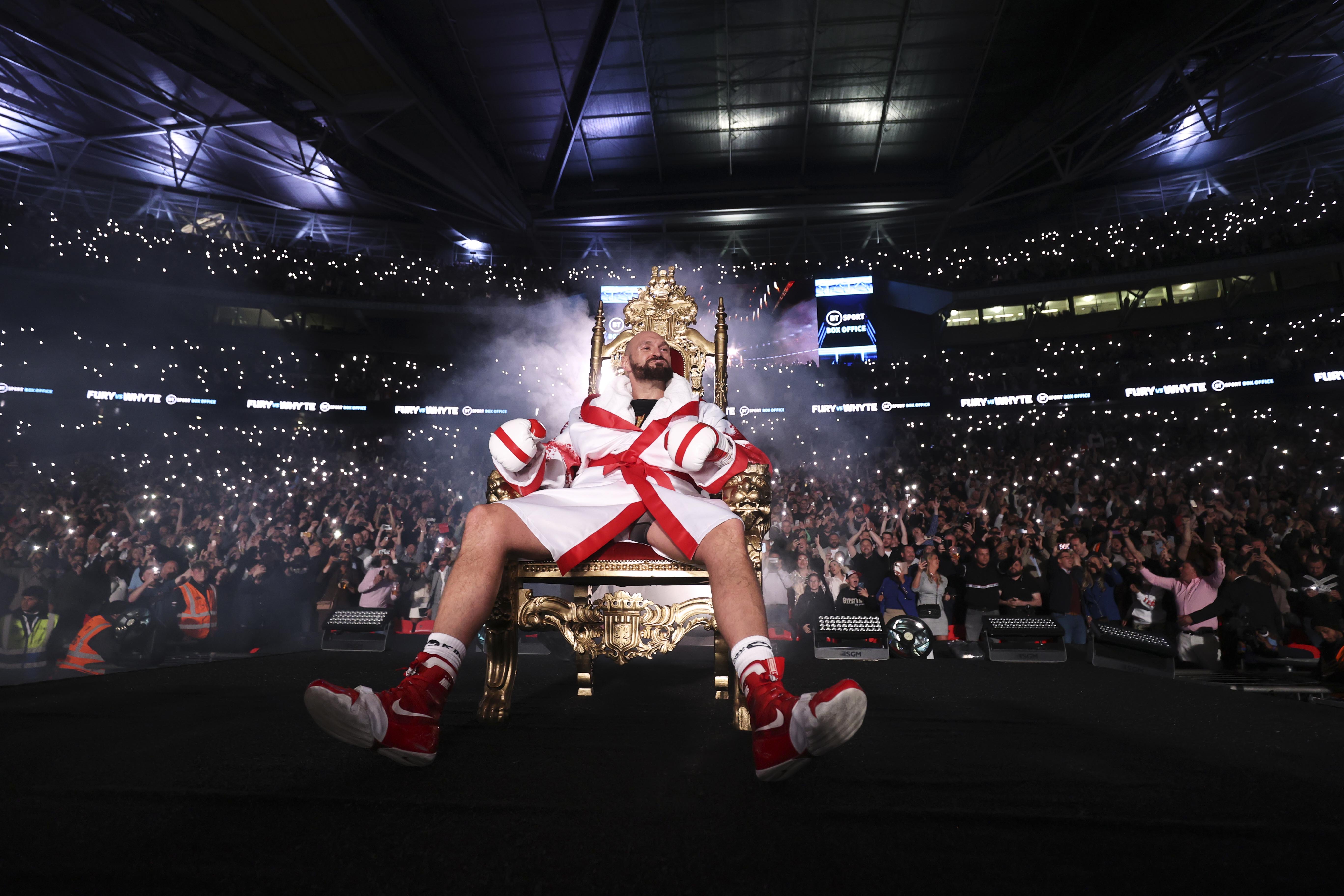 Tyson Fury on a gold throne before a boxing match.