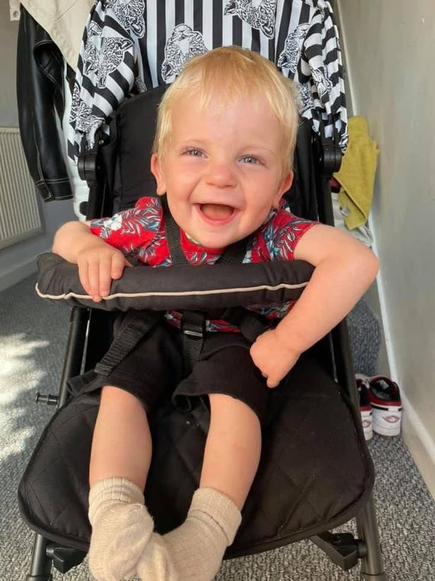 Myles smiling in a buggy