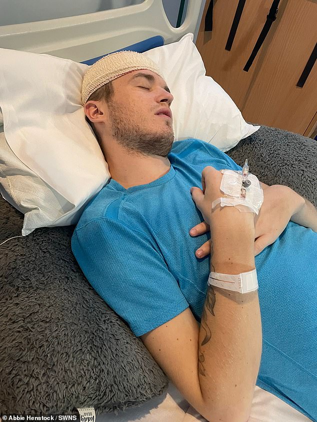 The 26-year-old, Kieran, who thought he had the flu, on a hospital bed before his third surgery