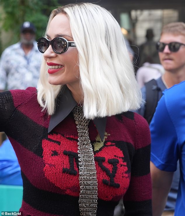 The Oppenheimer actress accessorized with a chain mail tie, bringing the look together with towering platform heels and sunglasses
