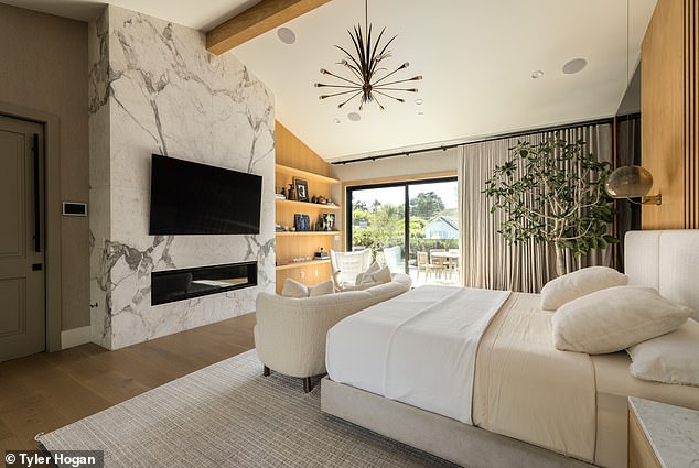 Natural lighting floods into this particular bedroom, which also boasts a marbled wall