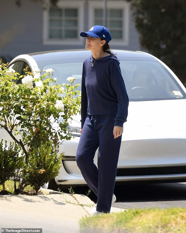 Trading in her famous beachside glamour, Valen stepped out in a cozy navy hoodie, matching sweatpants and white sneakers