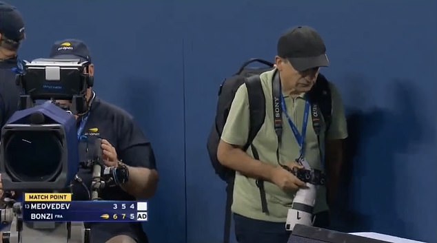 A photographer left his position and walked on to the court too early causing a disruption