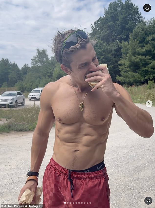As well as shots of the local cuisine, sights and his adorable pitbull Neon, Antoni also stripped off while hiking through a forest and went shirtless again in a video of him tucking into a delicious looking sandwich