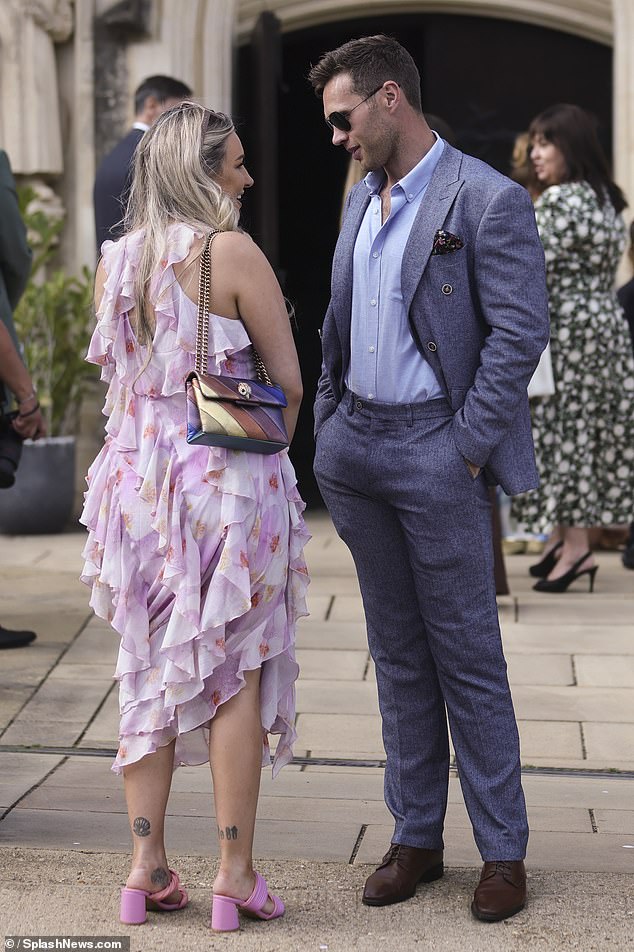 She wore a pair of striking pink sandals and toted her essentials in a metallic shoulder bag