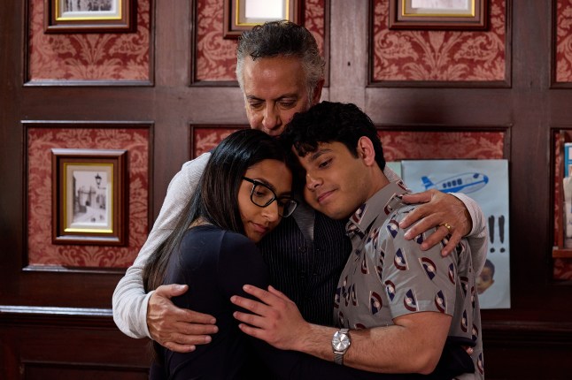 Asha, Dev and Aadi Alahan hug in the Rovers in Coronation Street