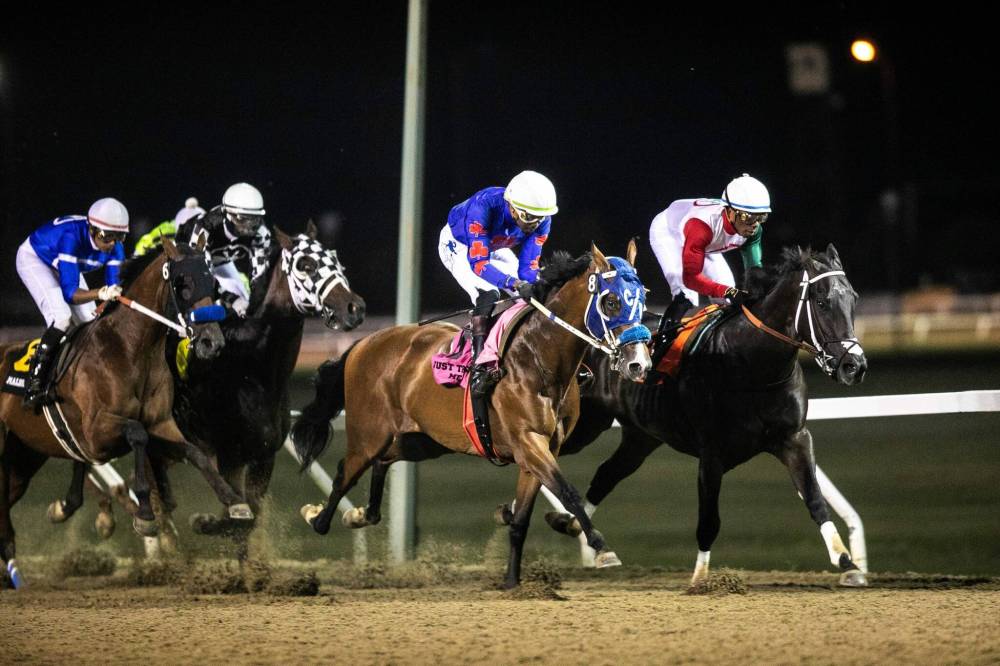 MIKAELA MACKENZIE / FREE PRESS
Attack (checkered colours) won the 77th Manitoba Derby Monday night after Take Charge Tom (right) was disqualified. In the Derby race, there were four complaints lodged involving five different horses.