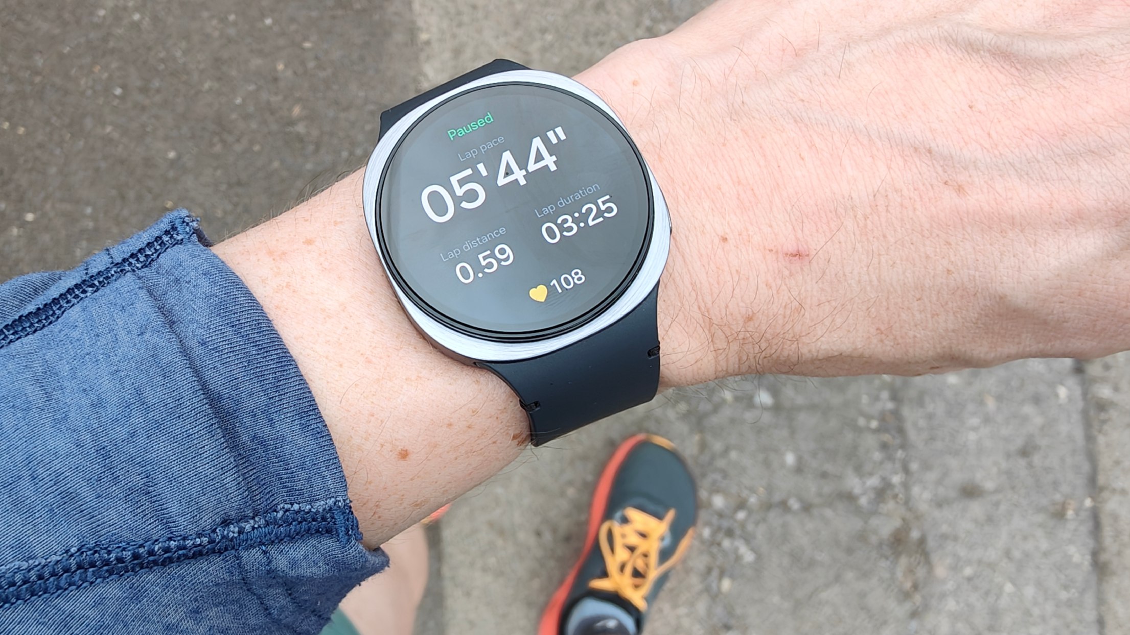 Samsung Galaxy Watch 8 and Garmin Venu X1 worn during run on separate wrists
