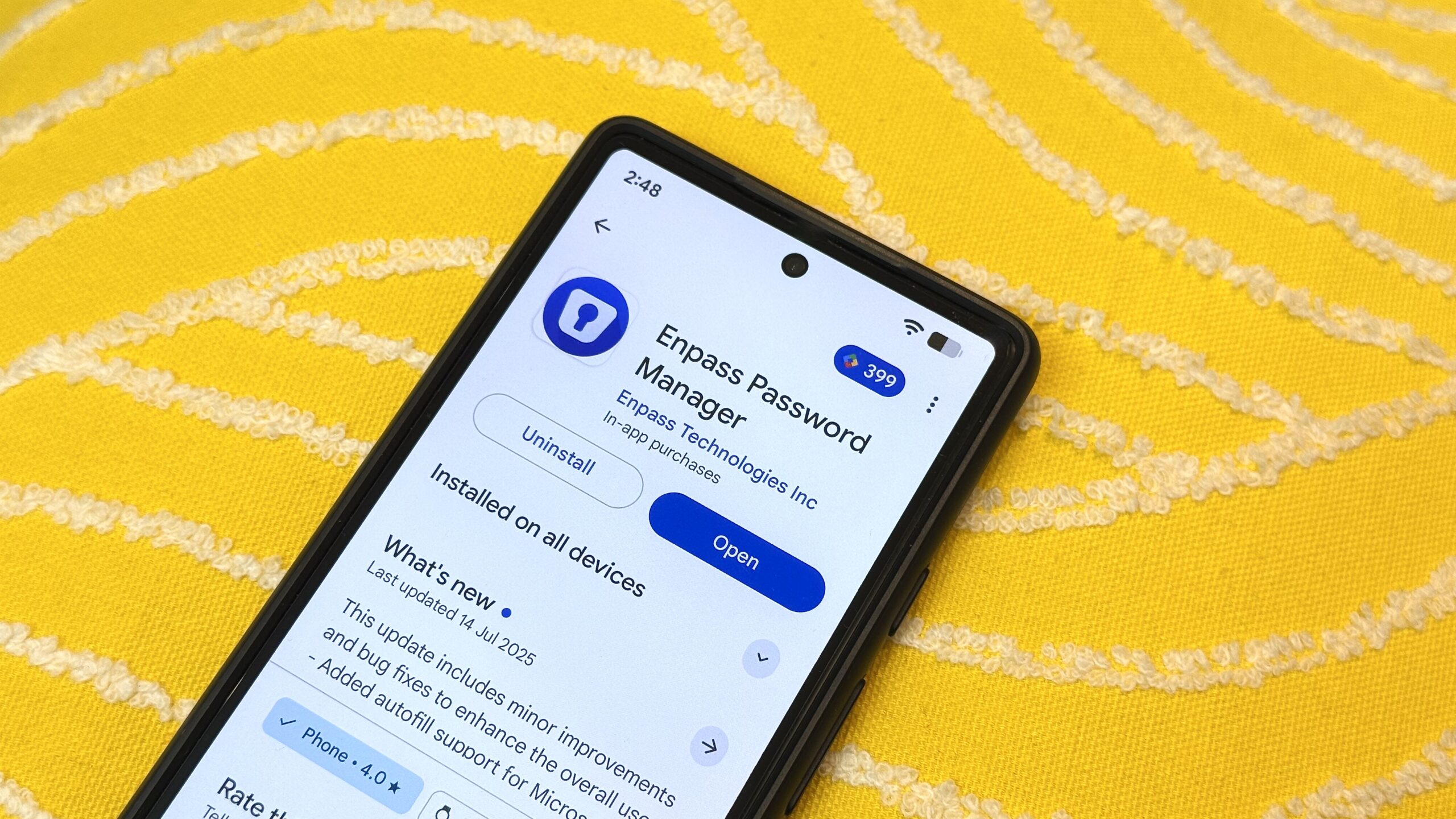 Enpass password manager on Play Store on a Pixel against a yellow background