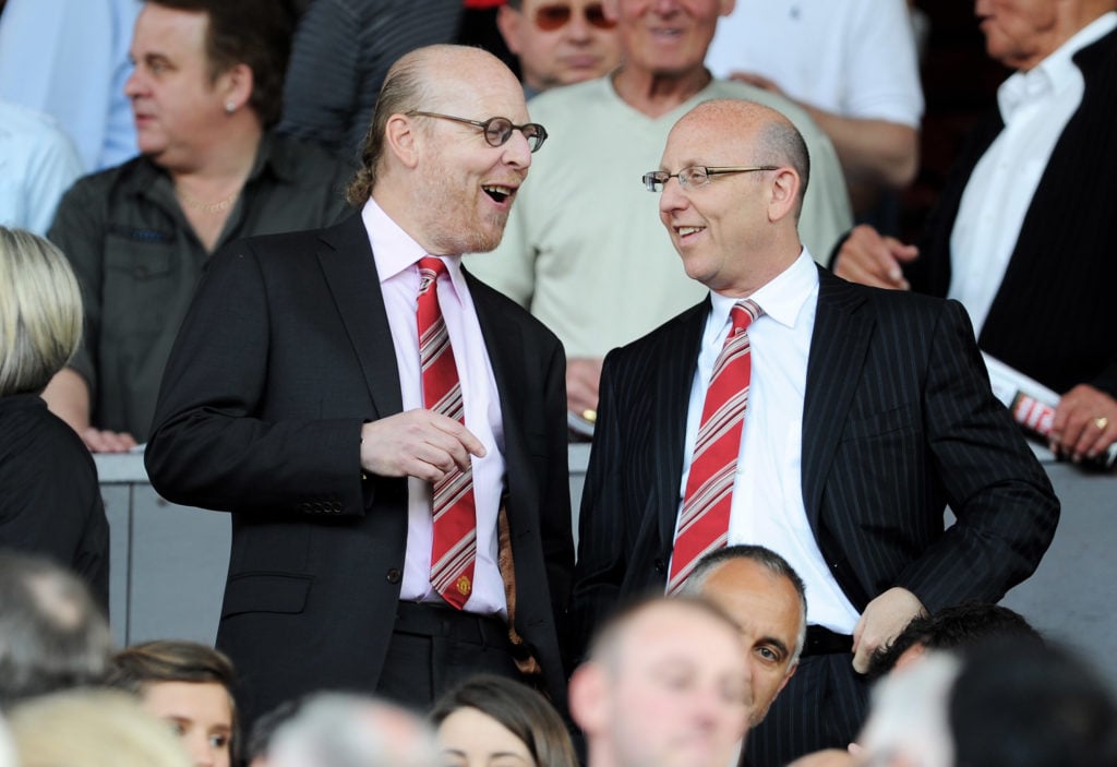 Joel and Avram Glazers, co-owners of Manchester United, converse at Old Trafford