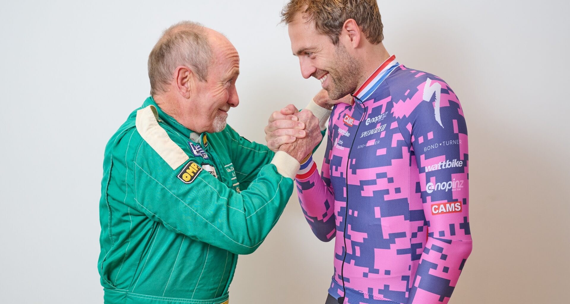 Alex Dowsett standing with his dad, clenching the other's fist in an arm-wrestle play-fight