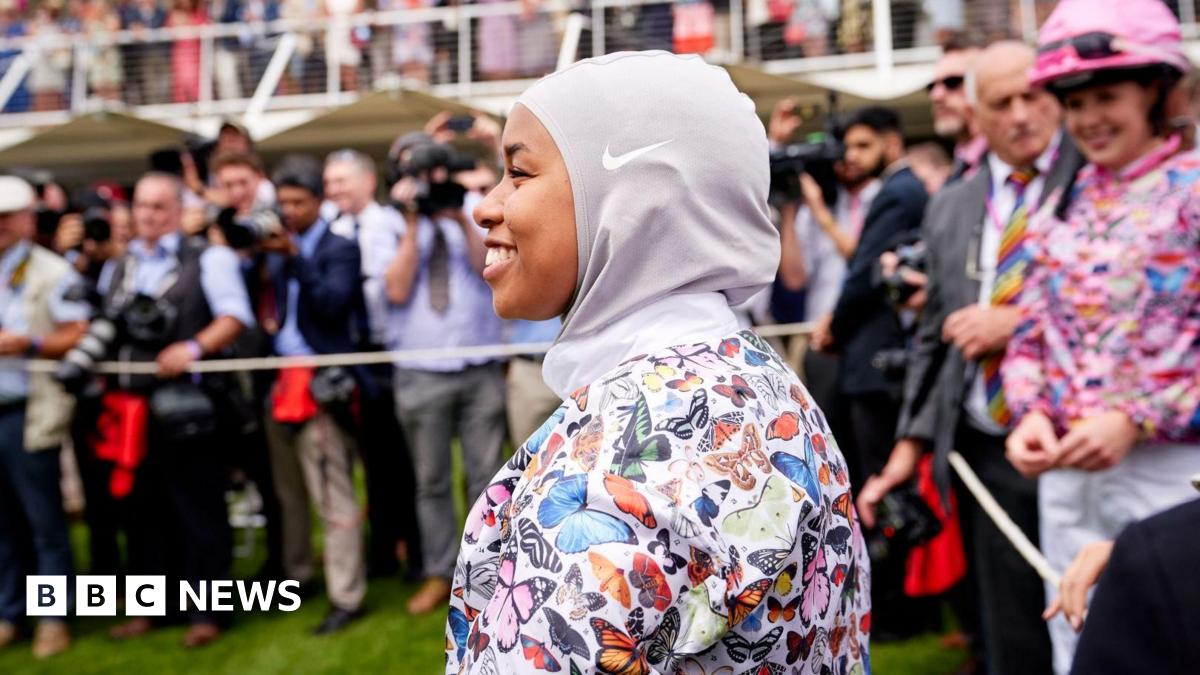 A Yangtze finless river porpoise underwater looks into the camera