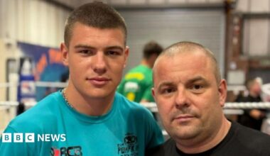 Ben Collins (L) and Carl Collins (R). Ben is wearing a light blue top with a chain around his neck, and short brown hair. Carl is wearing a black top and has a shaved head and slight stubble.