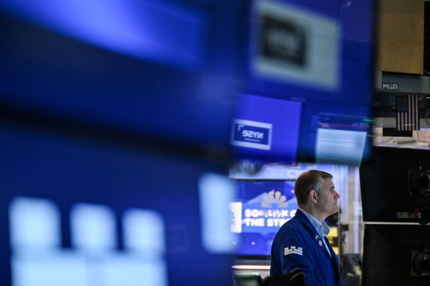 A trader works on the floor of the New York Stock Exchange at the opening bell on July 15.