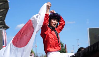 Ryusei Sakai proudly holds the Japanese flag aloft after victory at the Shergar Cup