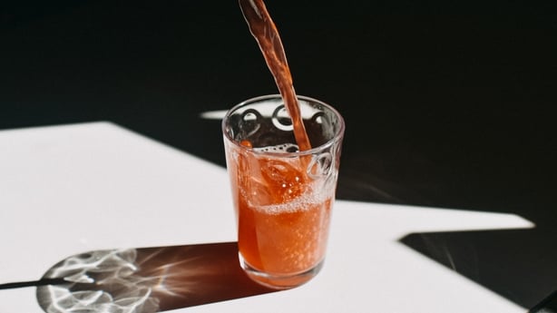Kombucha pouring in a drinking glass.