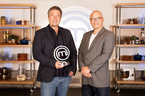 John Torode and Gregg Wallace standing side by side with MasterChef trophy