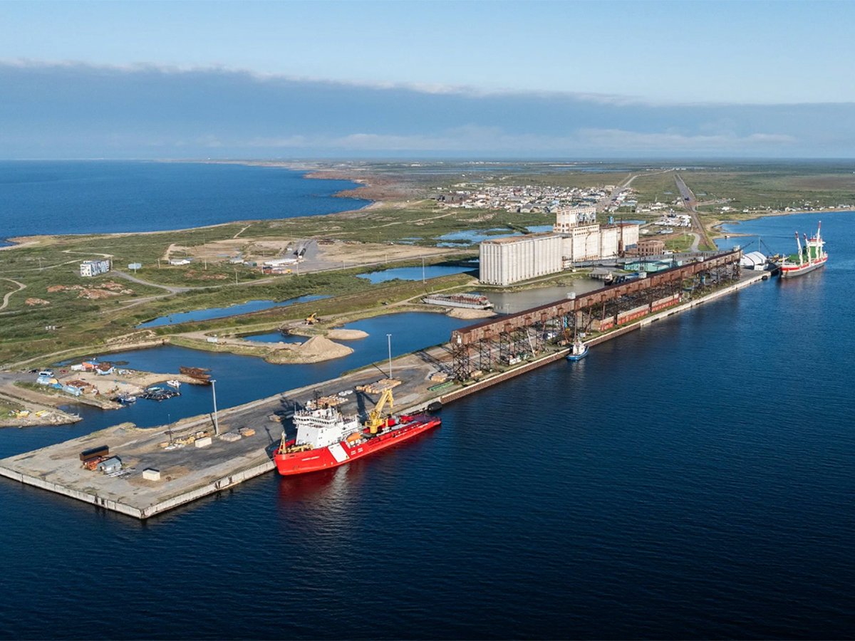 An aerial view of a red and white Canadian Coast Guard vessel dockside at the Port of Churchill.