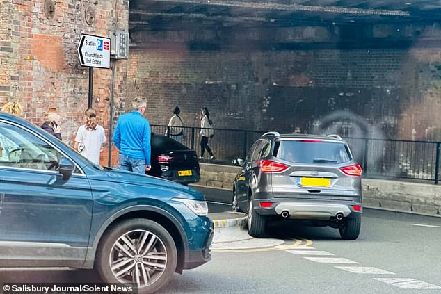 A car struggles to drive around the new foot-high kerb in Salisbury, Wiltshire