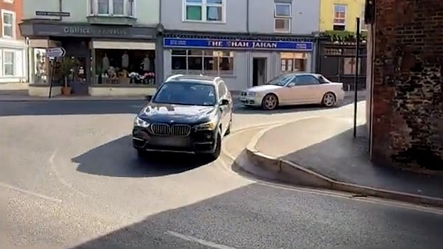Pictured: A driver attempts the tight corner where Salisbury's 'killer kerb' has caused damage to many cars