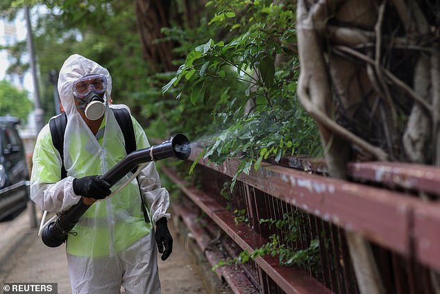 A worker sprays insecticide at a public housing estate following reports of imported cases of Chikungunya virus in Hong Kong, China, in August
