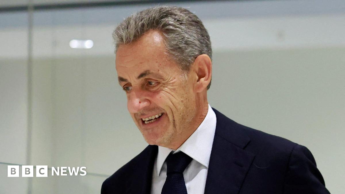 A resident walks with a shovel along a mud-covered road in Hualien on September 24, 2025, following the bursting of a barrier lake during the passing of Super Typhoon Ragasa.