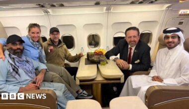 Amir Amiri, who had been detained in Afghanistan since December 2024, poses for a picture alongside Adam Boehler, the U.S. special envoy for hostage response, Sebastian Gorka, the deputy assistant to the U.S. president and senior director for counterterrorism, and a Qatari diplomat, on a plane from Kabul Afghanistan, September 28, 2025.