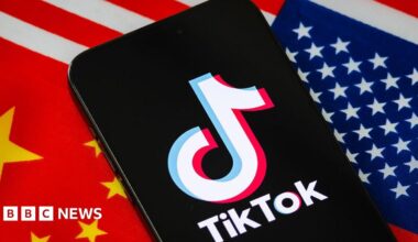 In this photo illustration, a smartphone displays the logo of TikTok, the short-video social media platform owned by China's ByteDance, with the national flags of China and the United States shown in the background.