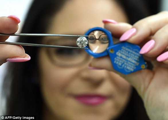 Lab-made gems are threatening to upset the diamond industry, with several companies worldwide now growing the stones for jewellery. In this image Pure Grown Diamonds CEO Lisa Bissell unveils a lab-cultivated diamond in New York in 2015