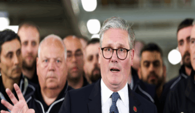 UK Prime Minister Keir Starmer (centre) speaks to the media after a phone conversation with US President Donald Trump, at a Jaguar Land Rover automobile manufacturing plant in the West Midlands back in May. JLR workers are crowded behind him.