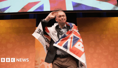 Former party leader Tim Farron wearing a Blackburn Rovers 'Pride of Lancashire' flag during a rally at the Liberal Democrats autumn conference