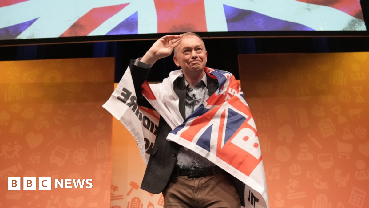 Former party leader Tim Farron wearing a Blackburn Rovers 'Pride of Lancashire' flag during a rally at the Liberal Democrats autumn conference