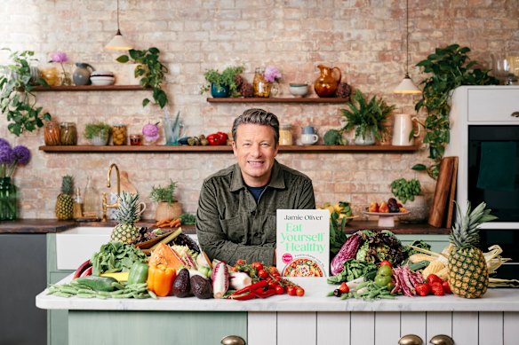 Jamie Oliver with his new cookbook, Eat Yourself Healthy. 