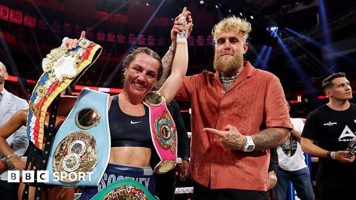 Ellie Scotney's hand is held up by Jake Paul